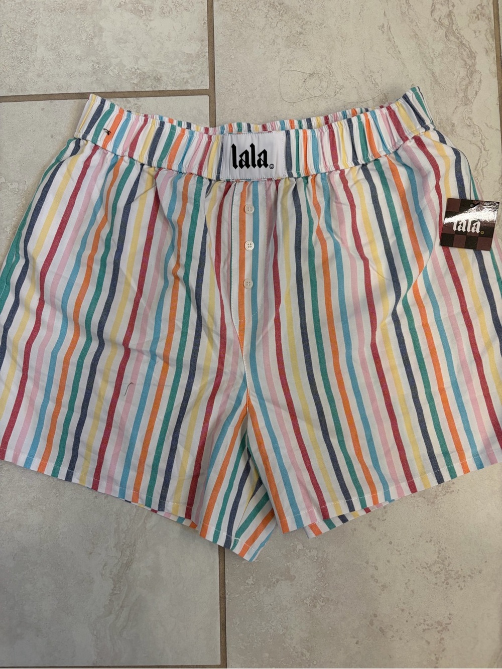 Dressed in LALA rainbow stripe boxer shorts